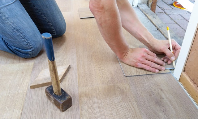 Image of Person Fixing Floor for Property Rehab
