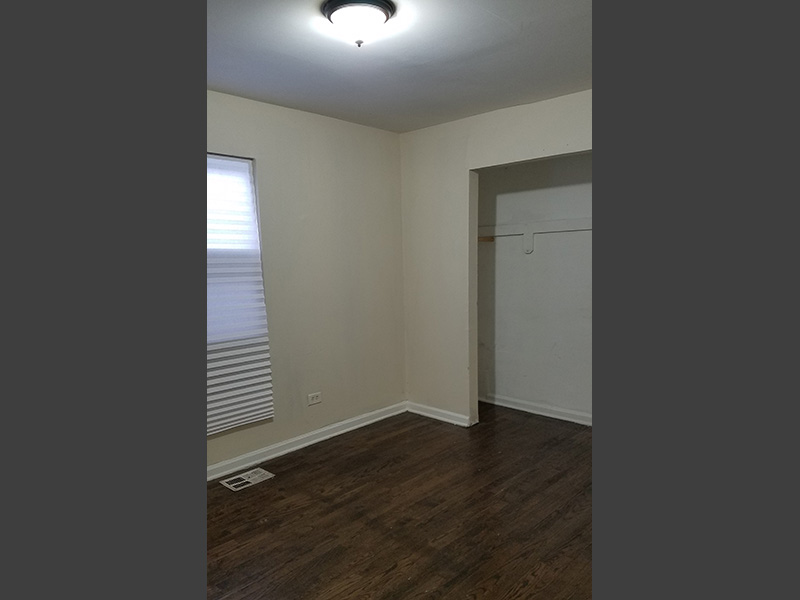 Bedroom with hardwood floors in 2059 W. 68th St Section 8 Property