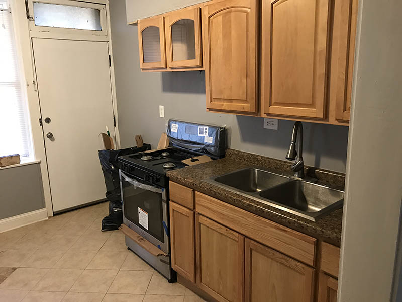 Interior kitchen view with new oven at 7332-34 S. May section 8 investment Property