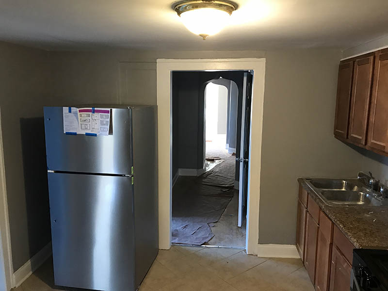 Interior kitchen view with new fridge at 7332-34 S. May section 8 investment Property